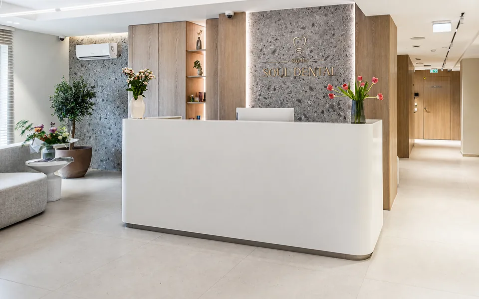 The reception desk at Soul Dental Studio: a light-filled lobby with armchairs, flowers and the clinic sign